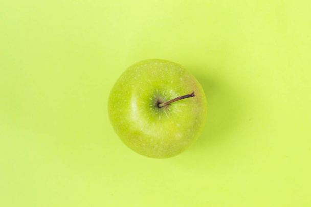 Green apple isolated on green background - Photo, Image