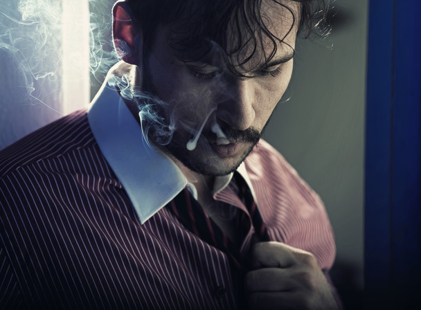 Smoking serious man after tiring job - Valokuva, kuva
