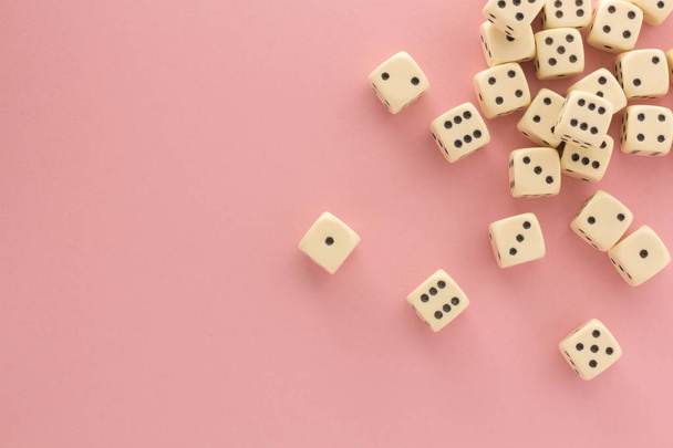 White gaming dices on pink background. victory chance, lucky. Flat lay, place for text. Top view. Close-up. Concept gamble. spectacular pastel - Foto, afbeelding