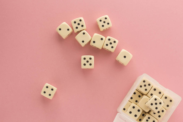 White gaming dices on pink background. victory chance, lucky. Flat lay, place for text. Top view. Close-up. Concept gamble. spectacular pastel - Foto, afbeelding