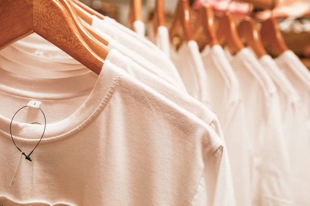 Blank white t shirts on hangers in the shopping mall - Photo, Image