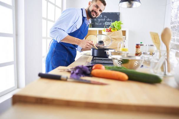 Man preparing delicious and healthy food in the home kitchen - Фото, зображення