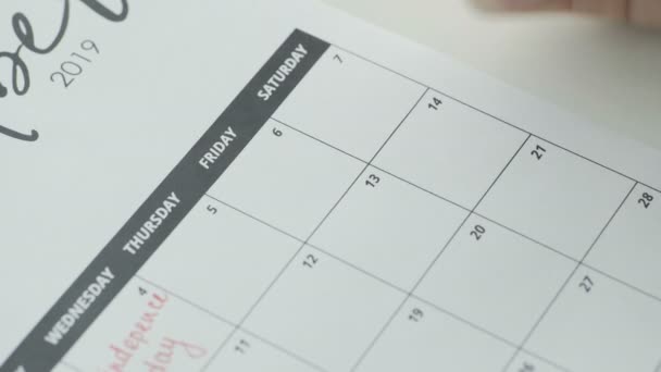 Womans hand writing with red pen on calendar word sex - Footage, Video