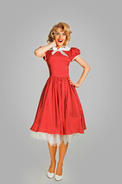 coquettish retro girl in spotted dress - Foto, afbeelding