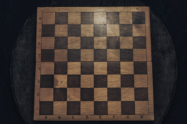 Old wooden chess board background. top view. - 写真・画像