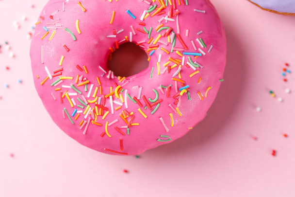 Concept of cooking, baking and food - close-up. Donut in pink glaze. Trend color. - Fotó, kép