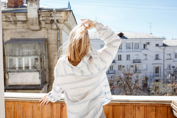 Pretty young woman in modern apartment stretching after wake up - Photo, Image