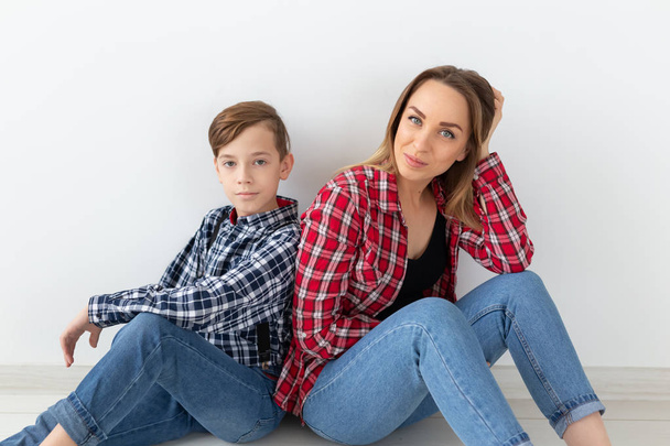 Mothers day, children and family concept - Beautiful woman and her son on white background - Photo, Image