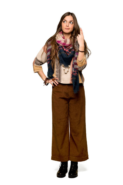Full-length shot of Young hippie woman with fingers crossing and wishing the best on isolated white background - Photo, Image