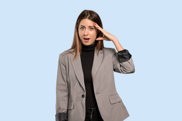 Business woman has just realized something and has intending the solution over isolated blue background - Photo, Image