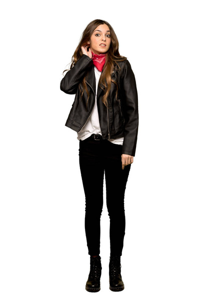 Full-length shot of Young woman with leather jacket having doubts on isolated white background - Zdjęcie, obraz