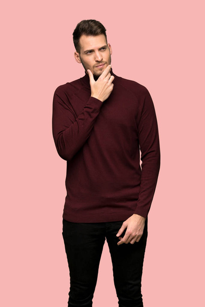 Man with turtleneck sweater thinking over pink background - Foto, Imagem