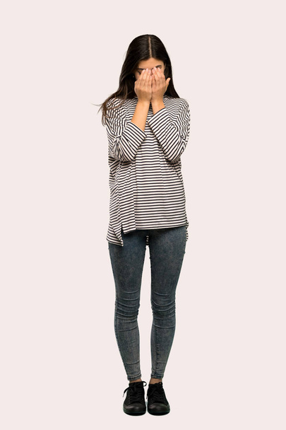 A full-length shot of a Teenager girl with striped shirt with tired and sick expression over isolated background - Фото, зображення