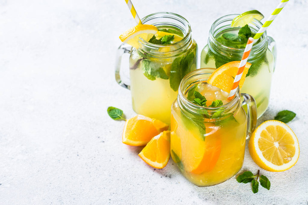 Lemonade, mojito and orange lemonade on white. - Фото, изображение