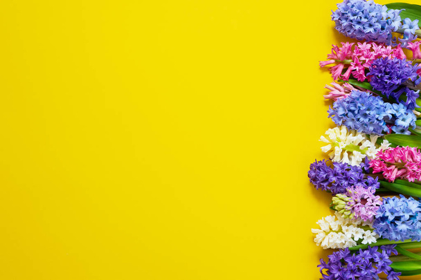 Hyacinth flowers bouquet on yellow background. Top view, copy space. - Foto, Bild