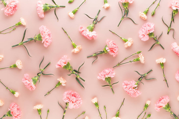 Pink carnation flowers on pastel background. Flat lay, top view, - Фото, изображение