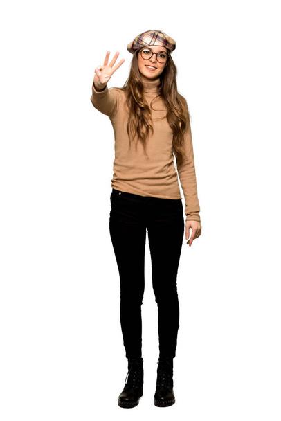Full-length shot of Young woman with beret happy and counting three with fingers on isolated white background - Fotografie, Obrázek