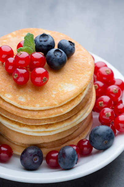 Stack of pancakes with blueberry and fresh berry. - 写真・画像