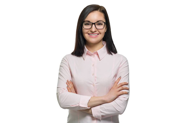 Portrait of young confident smiling woman in glasses with folded hands on white isolated background - Photo, Image