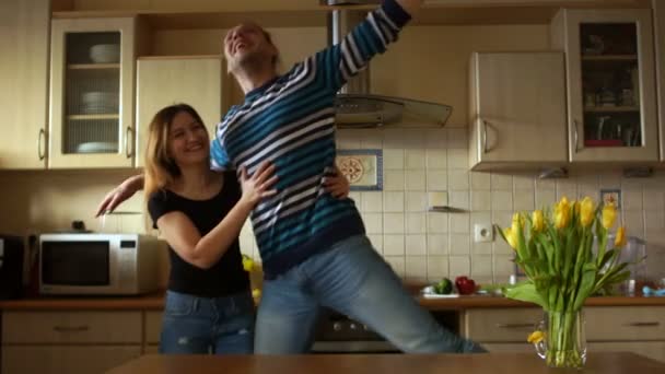 Young and perky students fool around in the kitchen, laugh and have fun - Video