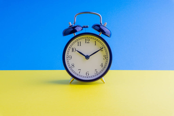 Alarm Clock on colorful background with selective focus and crop fragment. Copy space concept - Photo, Image