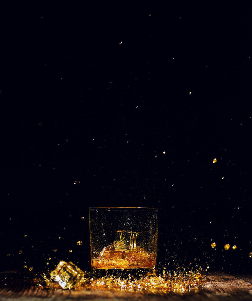 Isolated shot of whiskey on wooden background - Фото, изображение