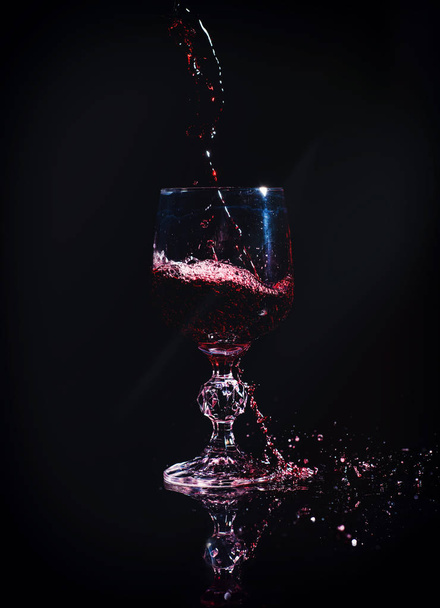 Red wine pouring into wine glass - Фото, изображение