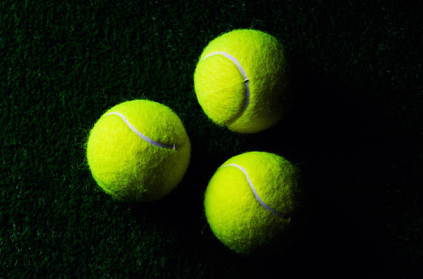 Tennis Ball isolated on black with dramatic lighting - 写真・画像
