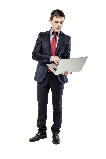 Attractive young business man with laptop on white backhground - Foto, Imagem
