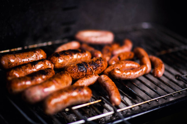 Grilled sausage on the flaming grill - Foto, imagen