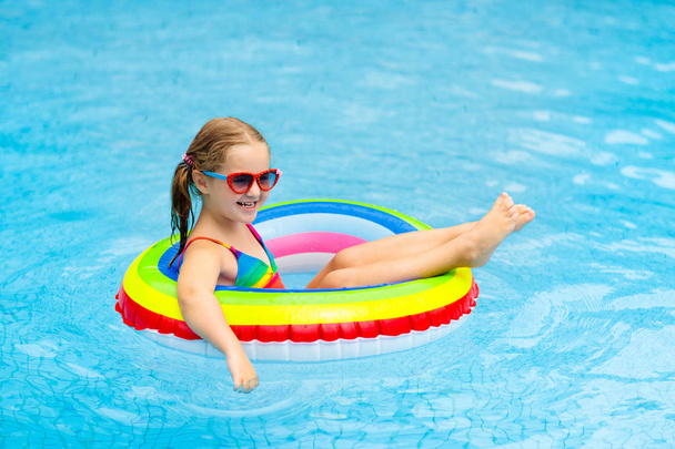 Child in swimming pool on toy ring. Kids swim. - Fotoğraf, Görsel