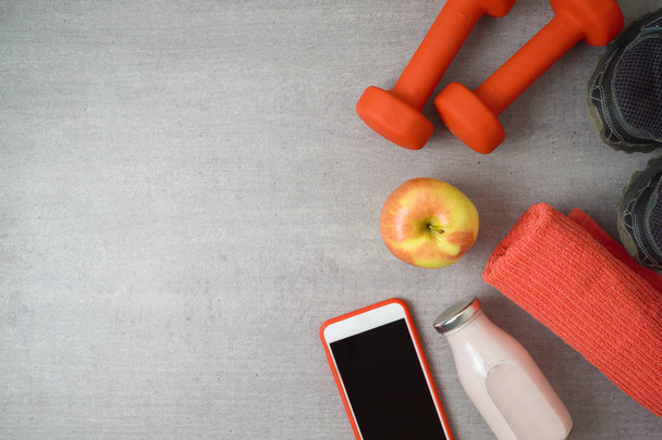 Fitness background with dumbbells, protein shake, apple and towe - Fotoğraf, Görsel