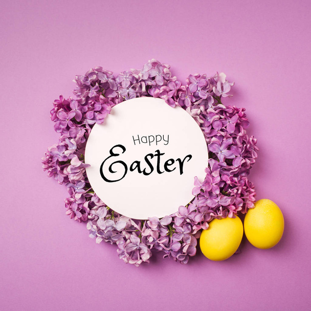 yellow Easter egg as Lily of the valley flower on purple background. minimalism, copy space. happy Easter text. - Photo, image
