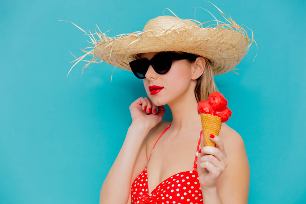 Young woman in red bikini and straw hat with ice cream  - Photo, image
