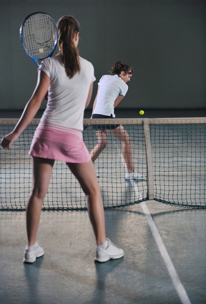 Young girls playing tennis game indoor - Foto, Imagem