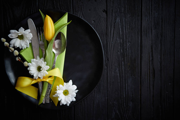 Easter spring table dishware composition with yellow tulip flower - Фото, изображение