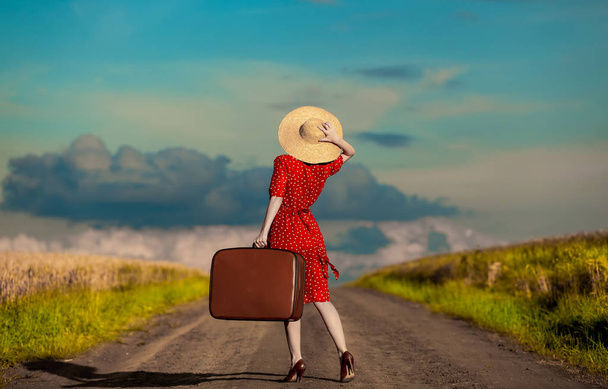 femme avec valise de voyage sur la route de campagne
  - Photo, image