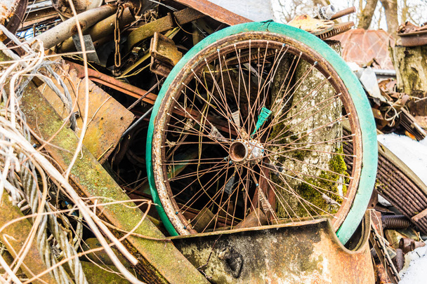 old bicycle wheel at the dump, scrap metal from household waste, recyclable secondary resources - Photo, image