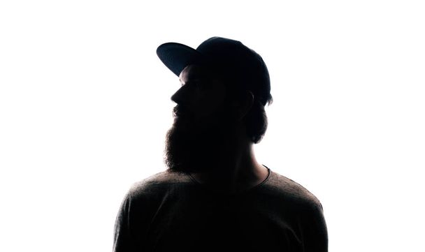 Bearded Man portrait silhouette in backlight. Handsome bearded mna looking away on white background - Photo, image