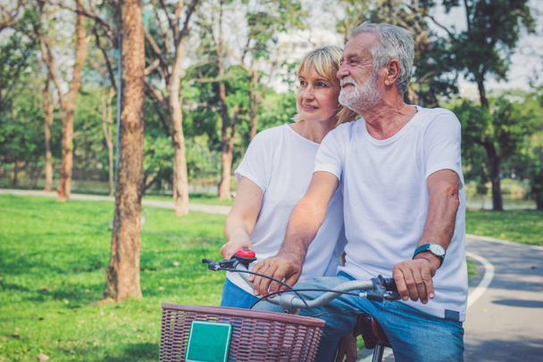 Senior couple on cycle ride in countryside - Фото, изображение