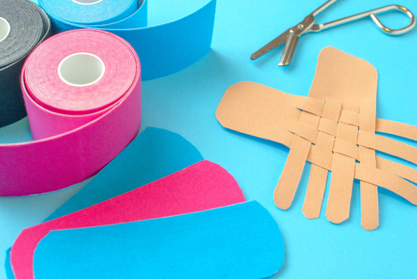 colored kinesio tapes with a pair of scissors - Photo, Image