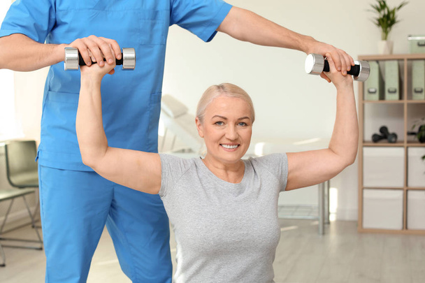 Physiotherapist working with patient in clinic. Rehabilitation therapy - Foto, Imagem