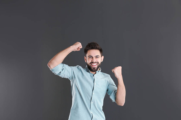 Portrait of happy young man on grey background - Zdjęcie, obraz