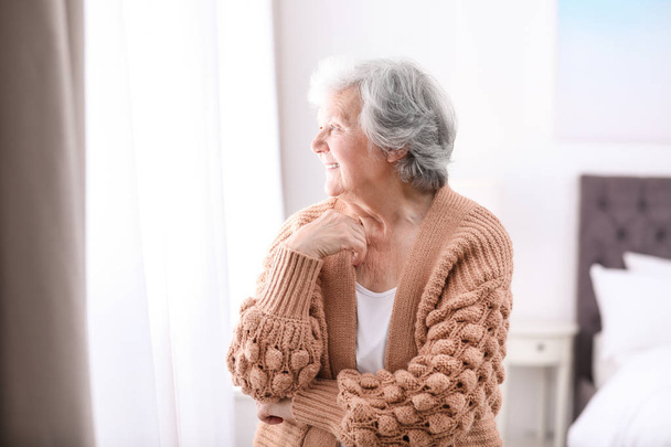 Portrait of beautiful grandmother in sweater at home - Fotoğraf, Görsel
