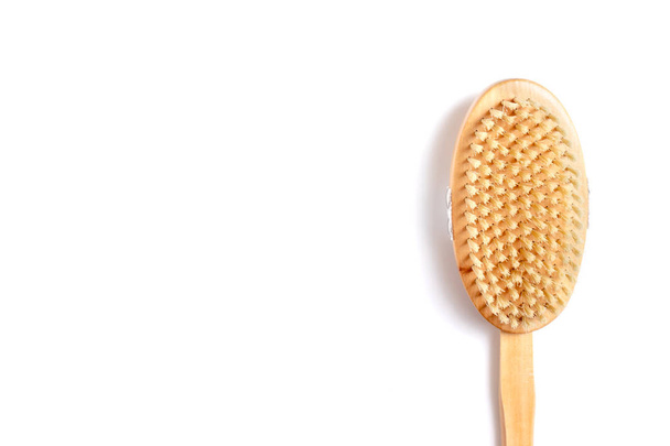 Wooden body brush for massage and scrub on white background with copy space - skincare in shower and bath - 写真・画像
