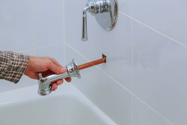 Plumber installing water faucet in the bathroom - Photo, Image