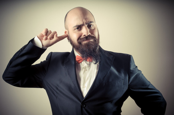funny elegant bearded man with finger in the ear - Fotografie, Obrázek