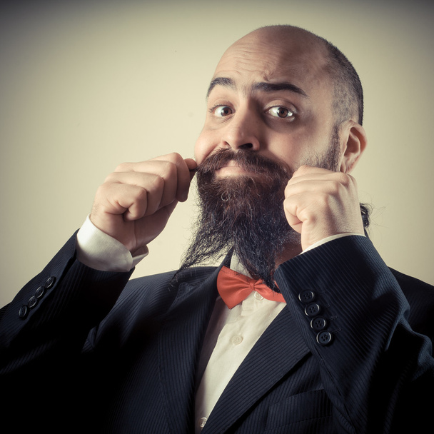 смешной элегантный бородатый мужчина трогает усы
 - Фото, изображение