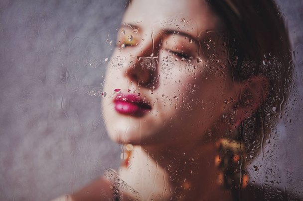 woman with makeup and earring with rain drops - Foto, afbeelding