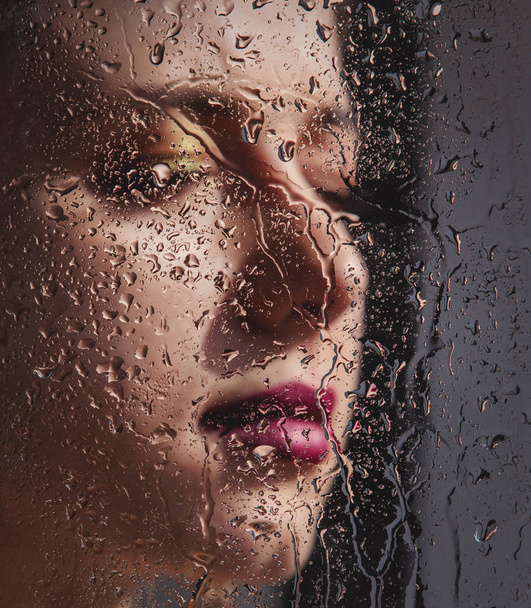 woman with makeup and earring with rain drops - Photo, Image